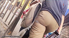 Ass young Arab woman with curly hair and olive jeans